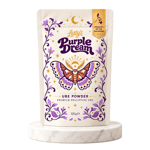 Letty's Purple Dream Ube Powder 125g on a marble pedestal against a warm cream background